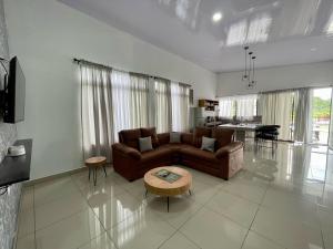 a living room with a couch and a table at Arenal Views, Pool & 5min to Waterfall & Town in Fortuna