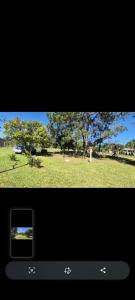 a view of a park with a car in a field at Sitio de Lazer in Eldorado do Sul +1 photo