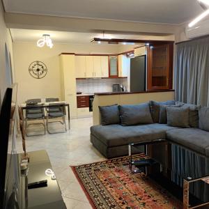 a living room with a couch and a kitchen at Homezie AGRIA in Agria +17 photos