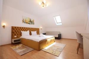 a bedroom with a large bed and a desk at Pensiunea Cavaler in Baile Felix +27 photos
