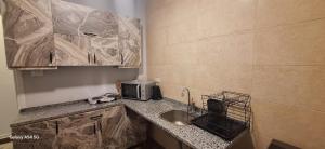a kitchen with a sink and a microwave at Elite Apartment In Cairo Downtown in Cairo +24 photos
