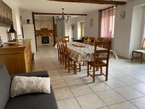 a kitchen and dining room with a table and chairs at La Grange de Flavigny in Flavigny