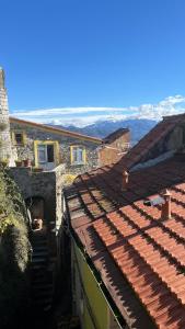 a view of the roofs of two buildings at Ancient townhouse next castle in Vezzano Ligure +2 photos