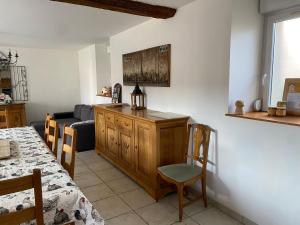 a kitchen and living room with a couch and a table at La Grange de Flavigny in Flavigny