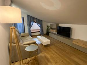 a living room with a couch and a flat screen tv at Mirador de Aledo in Aledo