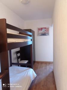 a bedroom with a bunk bed and a desk at résidence la citadelle in Saint-Florent +12 photos