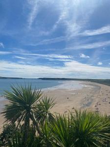 a beach with people on the sand and the water at THE Old DAIRY in Whitland