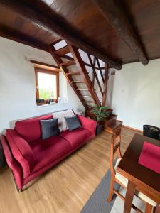 a living room with a red couch and a table at Rustico Corte in Brissago