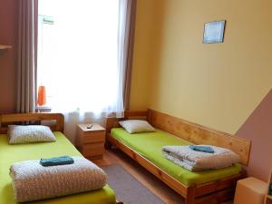 a room with two beds and a window at Dream Hostel & Apartments in Krakow