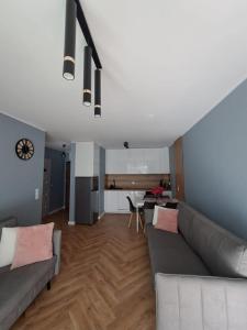 a living room with a couch and a table at E&M-Plażowa in Międzywodzie
