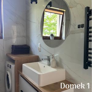 a bathroom with a sink and a mirror at Apartamenty Ku Dolinie in Wilków +13 photos