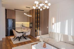 a living room and kitchen with a couch and a table at Lux residence Adrijana 1 in Ulcinj