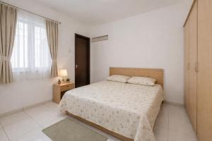a white bedroom with a bed and a window at Hotel king palace family stay in Agra