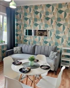 a living room with a couch and a table at Pokoje Alicja in Łeba