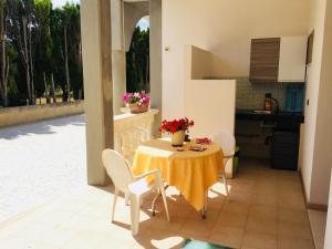 a kitchen and dining room with a table and chairs at Agriturismo Antico Vigneto in Otranto