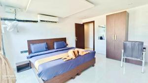a bedroom with a bed with a dog laying on it at Apex Inn Gulf View in Bangalore