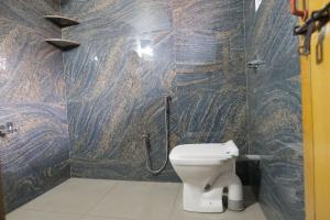 a bathroom with a shower with a toilet in it at Velankanni Home Stay in Mangalore +23 photos