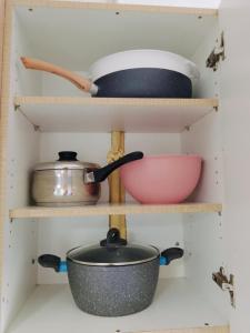 a shelf with pots and pans in a kitchen at ON THE SAND apartment in Artemida +25 photos