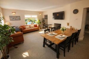 a living room with a table and a couch at Ferndale Lodge in Torquay