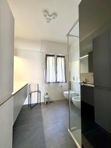 a bathroom with a toilet and a sink and a shower at Casa Mirit - Nesso in Nesso +33 photos