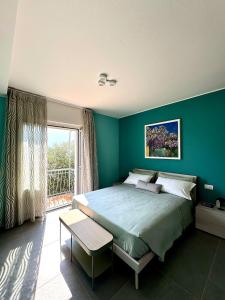 a bedroom with a large bed and a large window at Casa Mirit - Nesso in Nesso