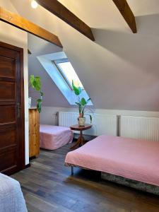 a attic bedroom with two beds and a skylight at Sodyba Viltis in Bikavėnai