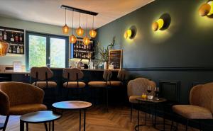 a bar with a row of chairs and tables at Hôtel des Vignes - Juliénas in Juliénas