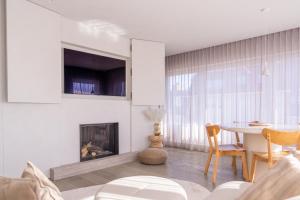 a living room with a table and a fireplace at Groenendijk 8 in Oostduinkerke