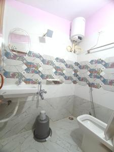 a bathroom with a toilet and a sink and a mirror at Ooty Gate Residency in Ooty +20 photos