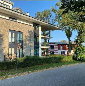 a brick building with a no parking sign next to a street at FEWO-Boddenblick-Vilm in Lauterbach
