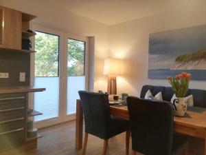 a dining room with a table and chairs at FEWO-Boddenblick-Vilm in Lauterbach +22 photos