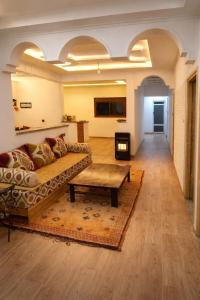 a living room with a couch and a coffee table at Chez BABAYO BY DADES in Zaouïet Sidi Daoud