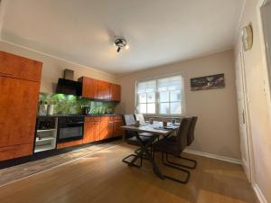a kitchen with a table and a dining room at Ferienhaus Mediterran in Bruttig-Fankel für 2-5 Personen in Bruttig-Fankel +21 photos