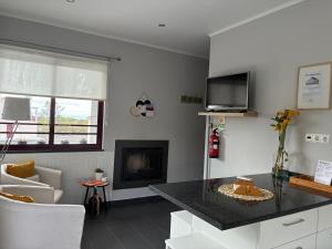 a living room with a tv and a fireplace at Vista Montanha in Madalena