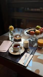 a table with two cups of tea and a plate of food at Ambit Boulevard Hotel Boutique in Santa Fe