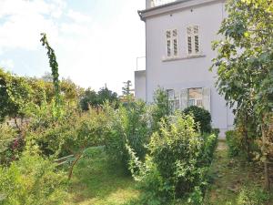 a white house with a garden in front of it at Apartment Butković 312 in Pula
