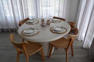 a white table with plates and wine glasses on it at Groenendijk 8 in Oostduinkerke +10 photos