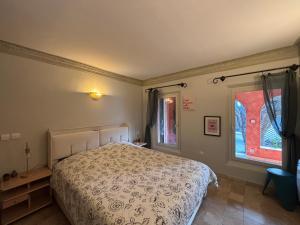 a bedroom with a bed and a window at Escapade entre Mer et Montagnes in Saint-Martin-du-Var