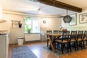 a dining room with a wooden table and chairs at Apartment in central Båstad in Båstad +8 photos