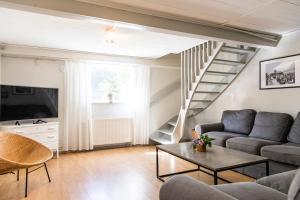 a living room with a couch and a table at Apartment in central Båstad in Båstad