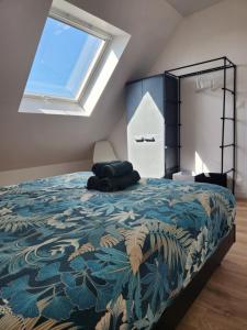 a bedroom with a large bed with a large window at O'Phare Ouest in Plouguerneau