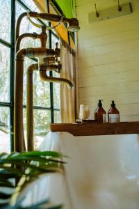 a bathroom sink with a faucet next to a window at Don Aniceto Lodges & Glamping in Luján