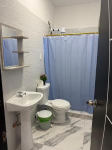 a bathroom with a sink and a toilet and a shower at Habitaciones de alquiler in La Libertad