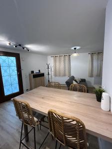 a large wooden table in a living room with chairs at Panach in Saint-Loubès +1 photo