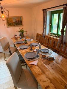 a dining room table with chairs and a wooden tableablish at Chata nad řekou Otavou in Vojníkov