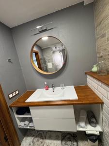 a bathroom with a sink and a mirror at TK apartamenti 3 in Rēzekne +5 photos