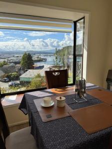 a dining table with a view of a large window at Cabañas del Puerto in Puerto Montt