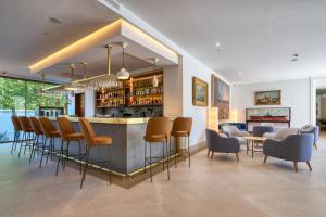 a bar in a restaurant with chairs and a counter at Hotel Ybarra Sevilla in Seville