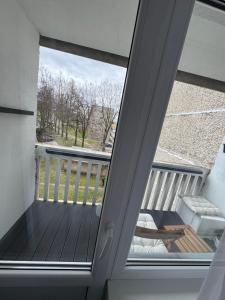 a room with a balcony with a sliding glass door at TK apartamenti 3 in Rēzekne