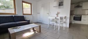 a living room with a couch and a table at Spessartblick Eisingen in Eisingen